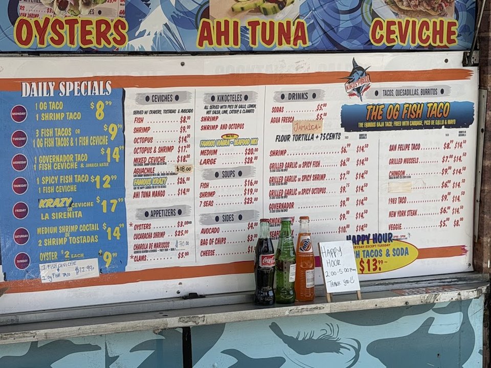 Seafood restaurant menu featuring tacos and shrimp.